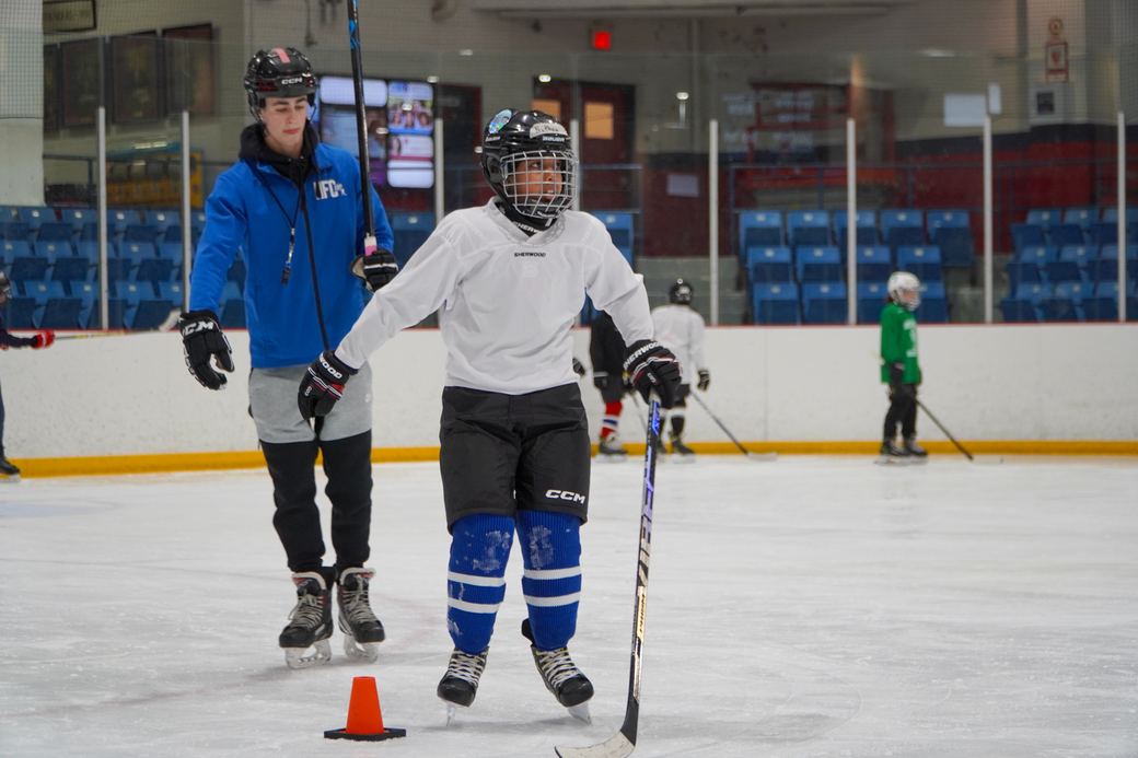 A coach demonstrating a stop to two campers