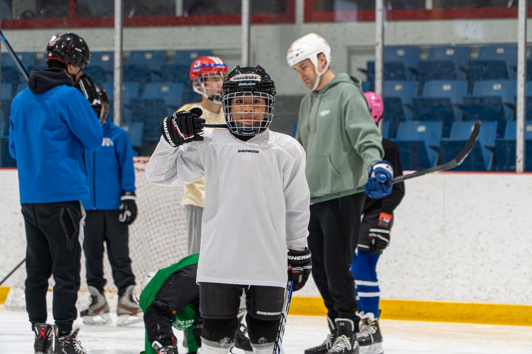 Campers clustered together at the side of the rink