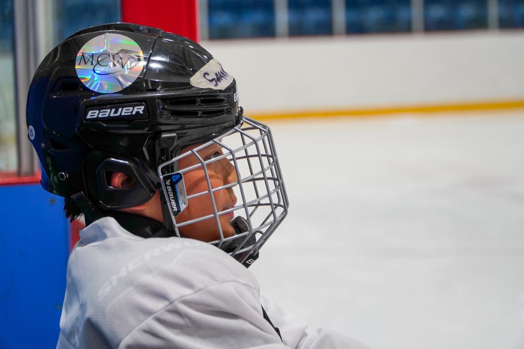 A camper in a black cage helmet close to the camera