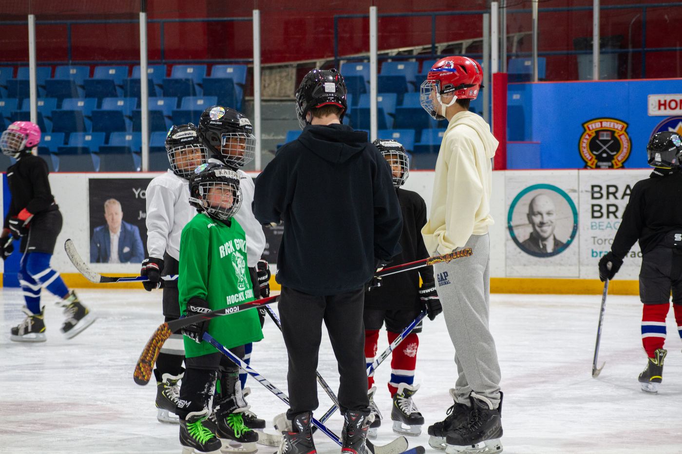 The full group lined up across the ice facing the coaches