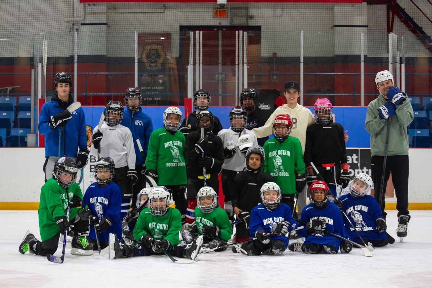 The March 2026 camp group crowded together on the ice
