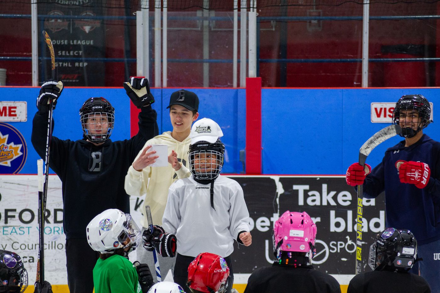 A member of the student executive briefing a group of campers gathered on the ice