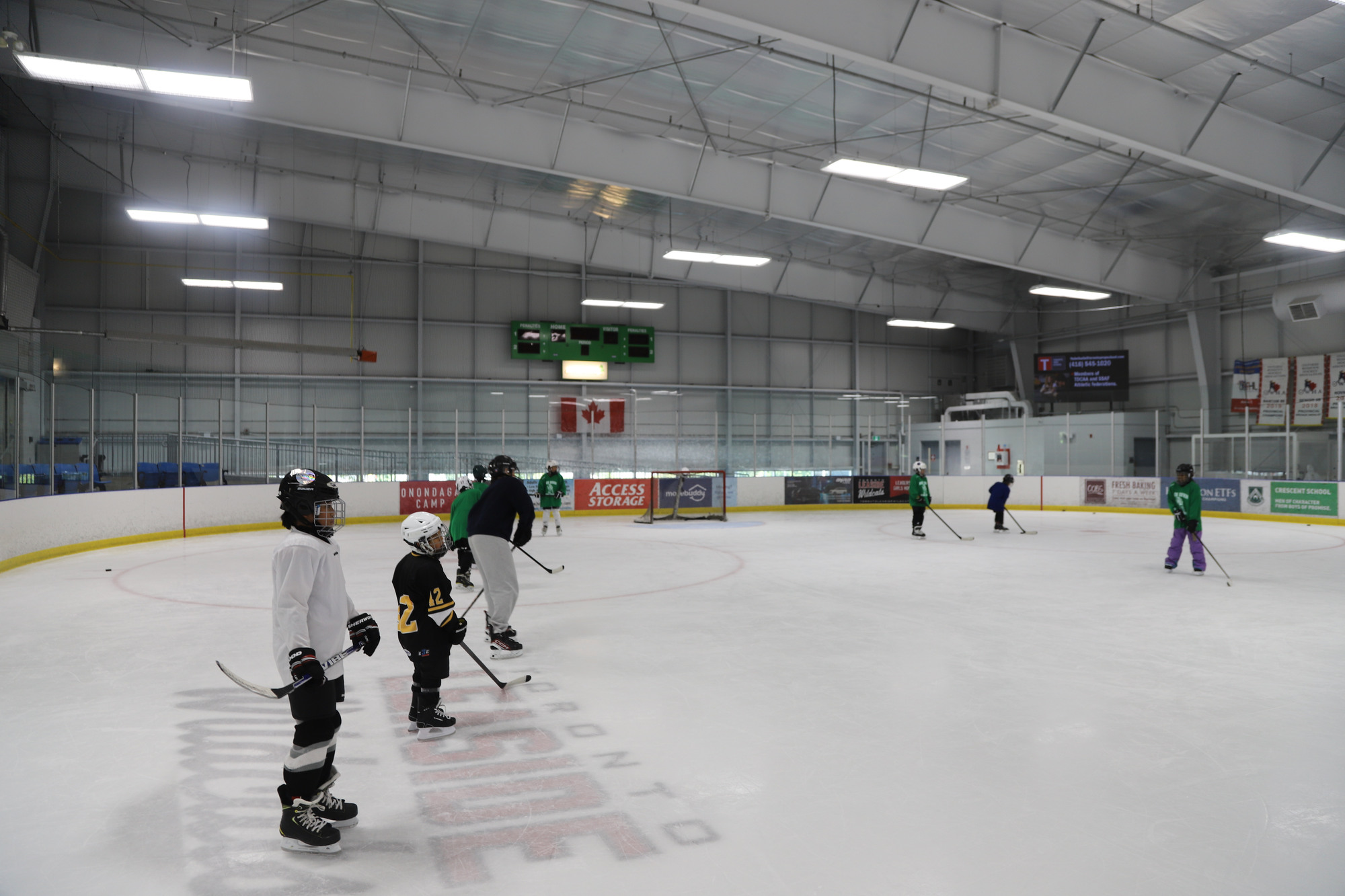 A wide view of the rink with campers spread out in a game