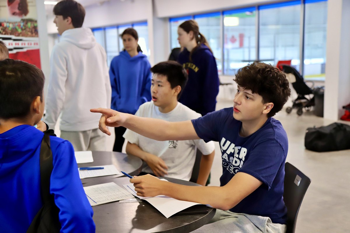 Open Ice team members welcoming families at check-in on the first morning of Summer Camp 2026